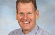 portrait headshot of man smiling